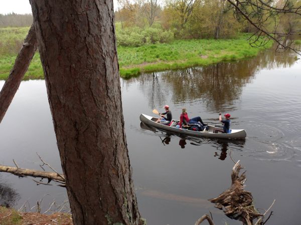 Dan/Brady leaving high bank campsite with Doug riding to retrieve canoe